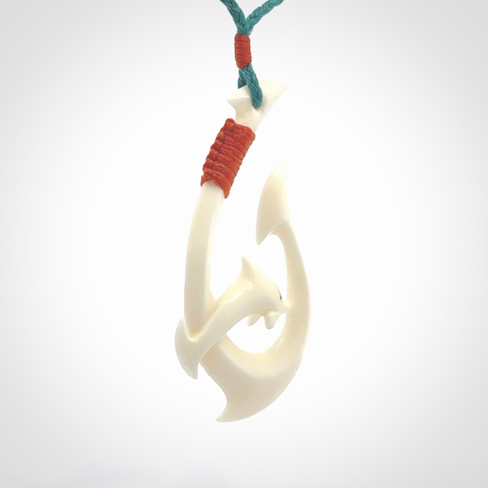 Hand carved bone hook with dolphin pendant. This is a marine-themed pendant which we have made for dolphin lovers and for those of us that love the sea. This piece is handcarved from natural bone and is shipped worldwide free.
