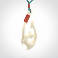 Hand carved bone hook with dolphin pendant. This is a marine-themed pendant which we have made for dolphin lovers and for those of us that love the sea. This piece is handcarved from natural bone and is shipped worldwide free.