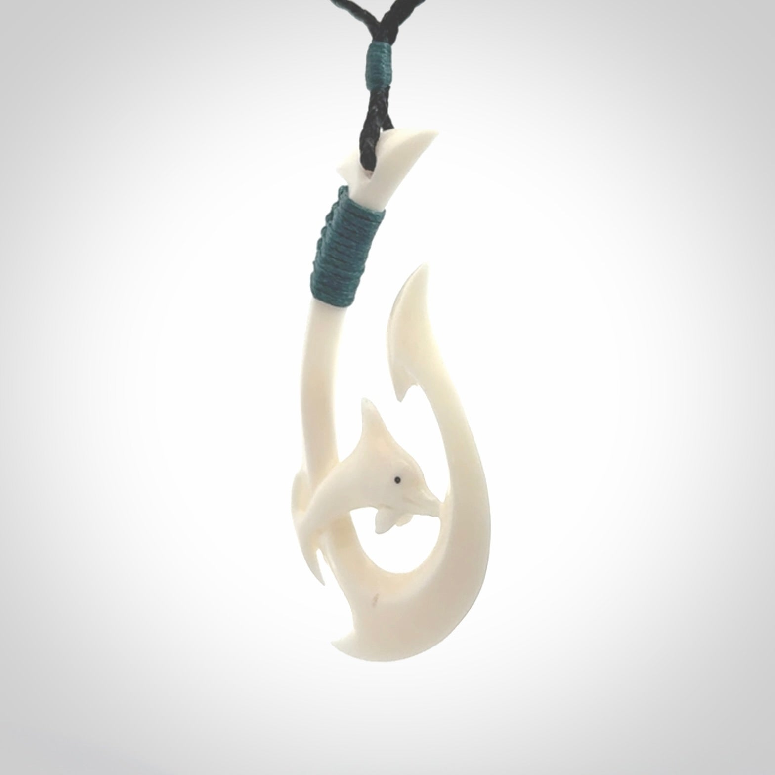 Hand carved bone hook with dolphin. This is a marine-themed pendant which we have made for dolphin lovers and for those of us that love the sea. This piece is handcarved from natural bone &nbsp;and is shipped worldwide free.
