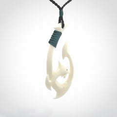 Hand carved bone hook with dolphin. This is a marine-themed pendant which we have made for dolphin lovers and for those of us that love the sea. This piece is handcarved from natural bone &nbsp;and is shipped worldwide free.