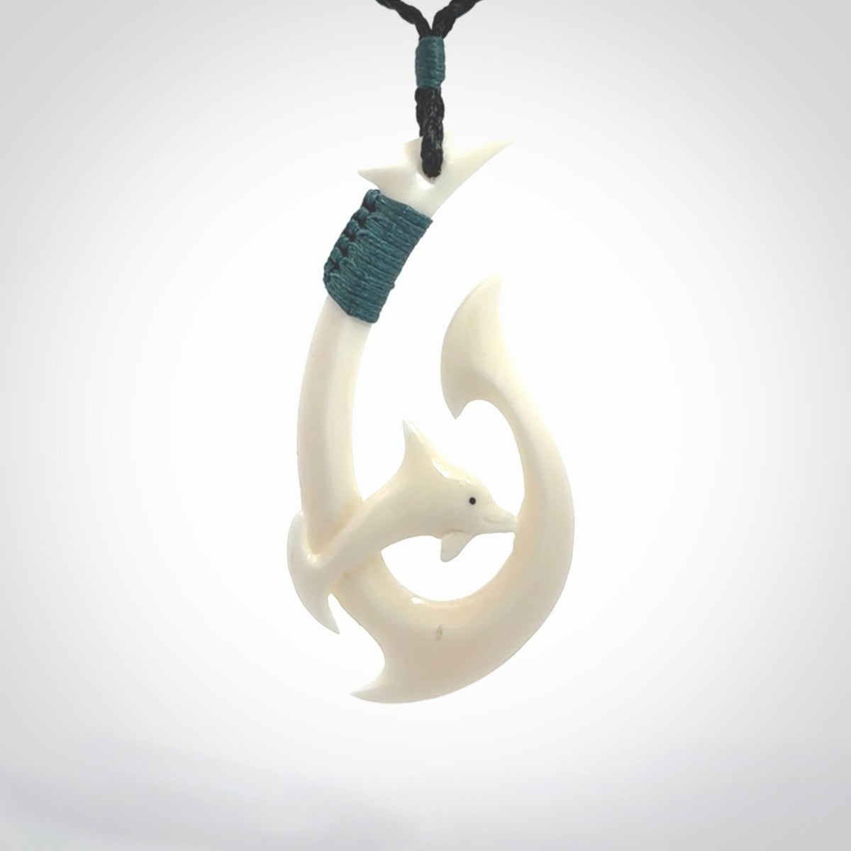 Hand carved bone hook with dolphin. This is a marine-themed pendant which we have made for dolphin lovers and for those of us that love the sea. This piece is handcarved from natural bone &nbsp;and is shipped worldwide free.