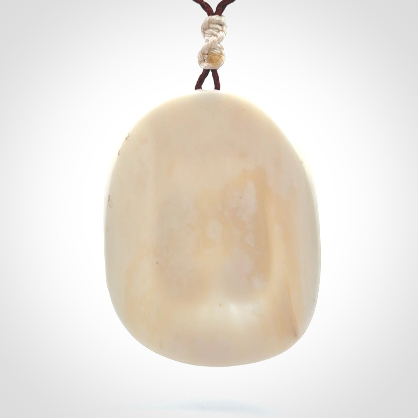 This is a contemporary large pendant carved in bone. Hand carved and provided with an adjustable cord. Twins in womb pendant.