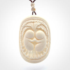 This is a contemporary large pendant carved in bone. Hand carved and provided with an adjustable cord. Twins in womb pendant.