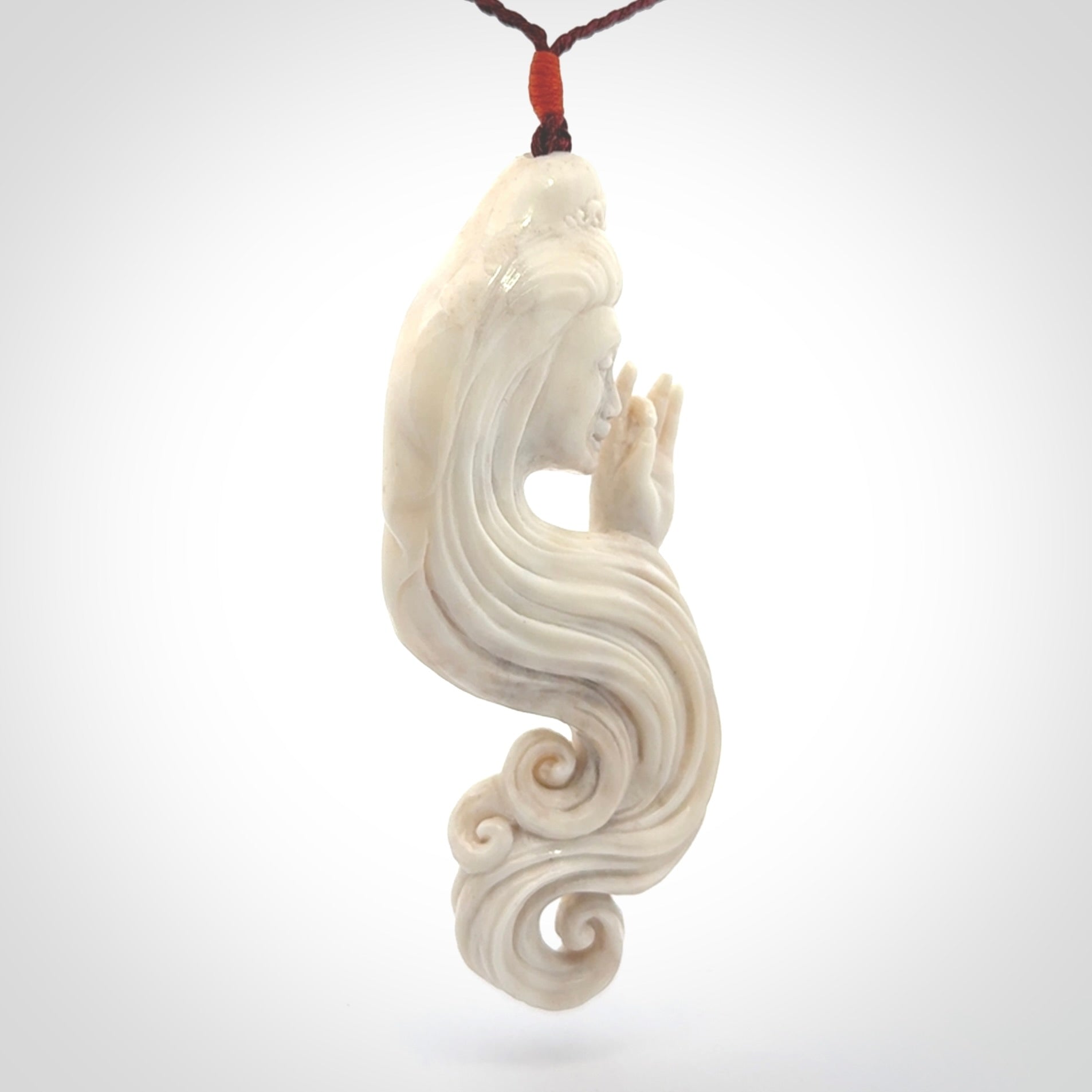 This is a contemporary large female pendant carved in bone. Hand carved and provided with an adjustable cord. Woman with shuni mudra hand gesture pendant.