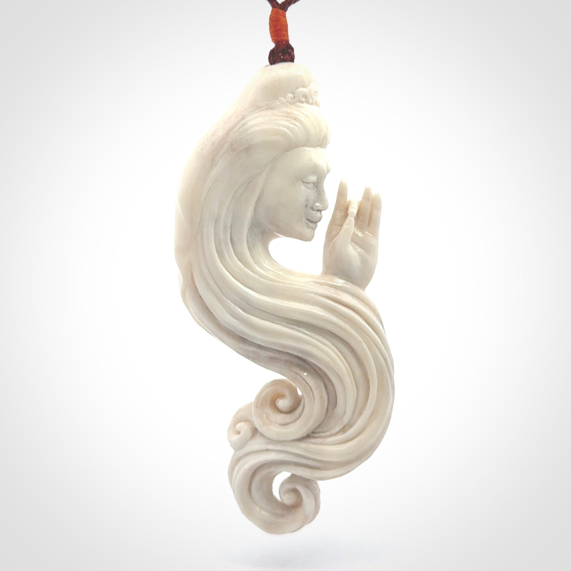 This is a contemporary large female pendant carved in bone. Hand carved and provided with an adjustable cord. Woman with shuni mudra hand gesture pendant.