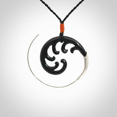 Hand carved pendant made from black jade with sterling silver. NZ Pacific contemporary Koru pendant for sale online.