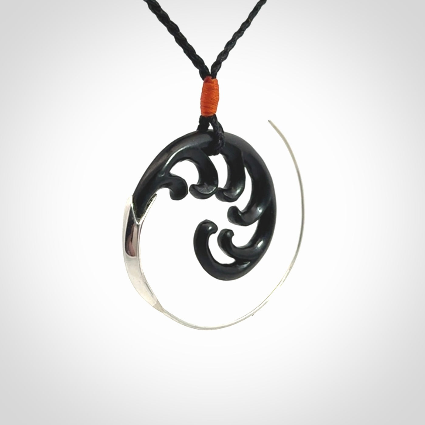 Hand carved pendant made from black jade with sterling silver. NZ Pacific contemporary Koru pendant for sale online.