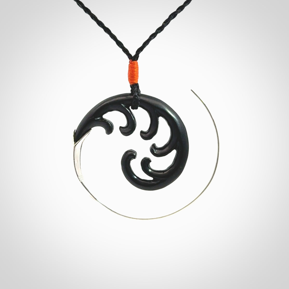 Hand carved pendant made from black jade with sterling silver. NZ Pacific contemporary Koru pendant for sale online.