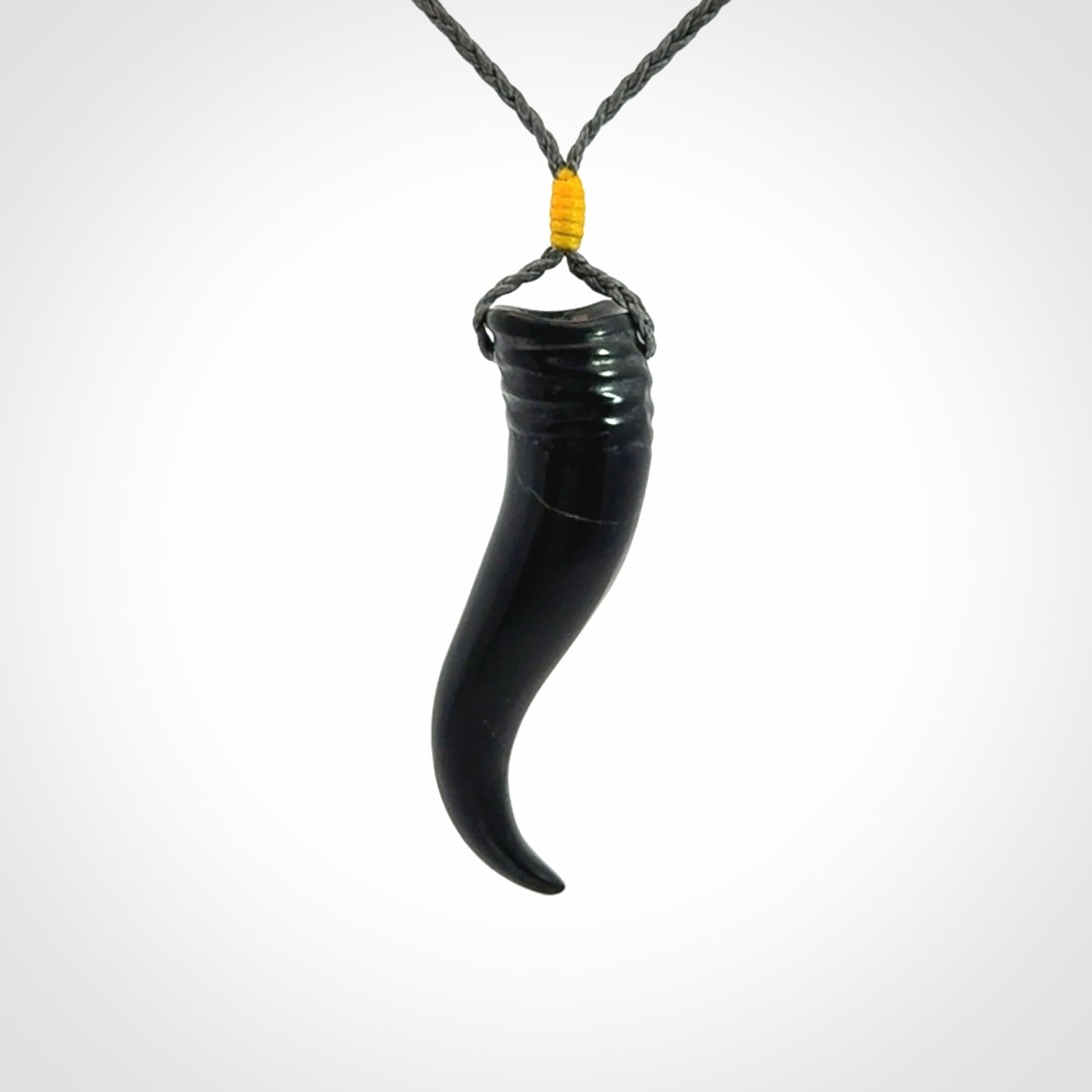 Black jade Italian Horn pendant. Handmade jade jewellery made by NZ Pacific and for sale online. Black Jade Goat Horn pendant worn for protection over evil eye, bad luck and promotes fertility. Ancient symbolic necklace hand made in Australian Black Jade.