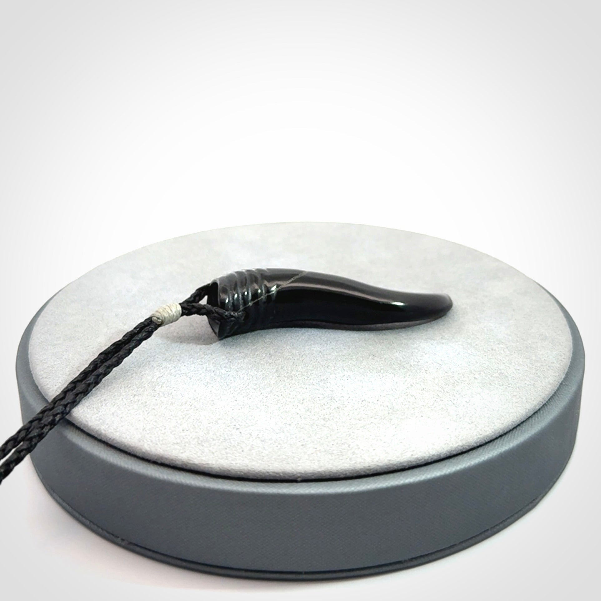 Black jade Italian Horn pendant. Handmade jade jewellery made by NZ Pacific and for sale online. Black Jade Goat Horn pendant worn for protection over evil eye, bad luck and promotes fertility. Ancient symbolic necklace hand made in Australian Black Jade.