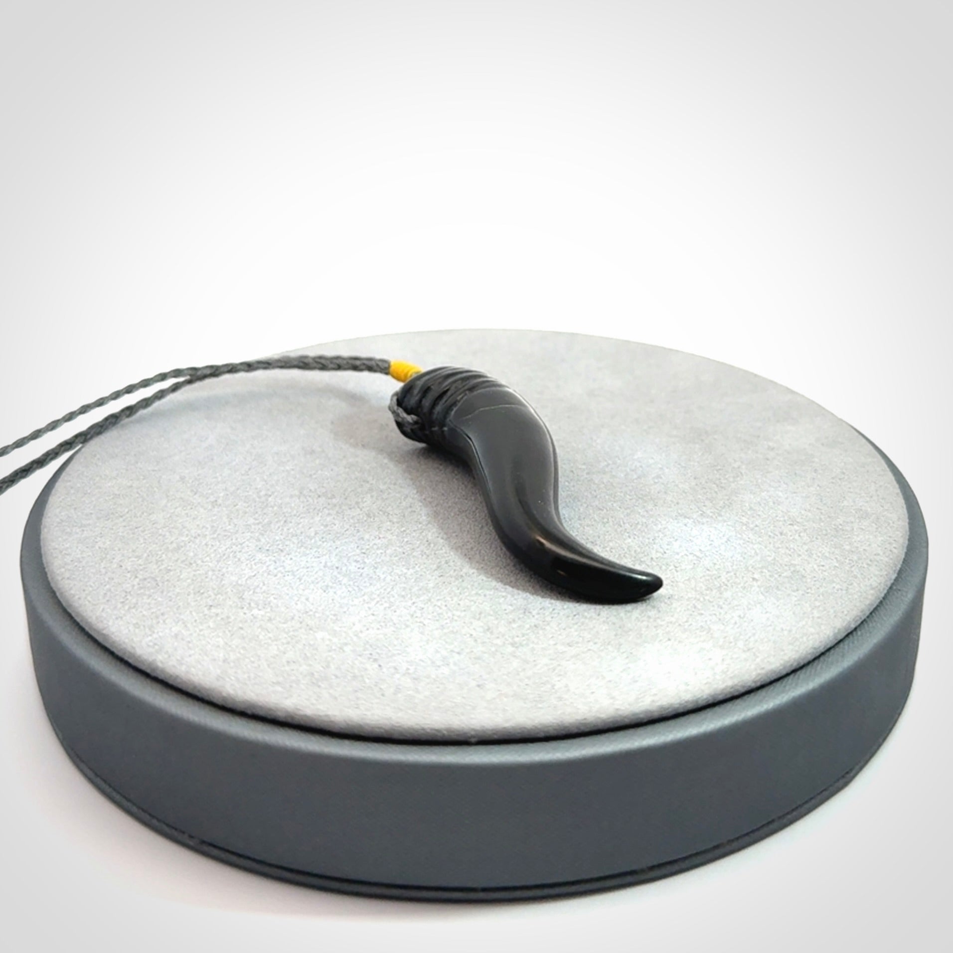 Black jade Italian Horn pendant. Handmade jade jewellery made by NZ Pacific and for sale online. Black Jade Goat Horn pendant worn for protection over evil eye, bad luck and promotes fertility. Ancient symbolic necklace hand made in Australian Black Jade.