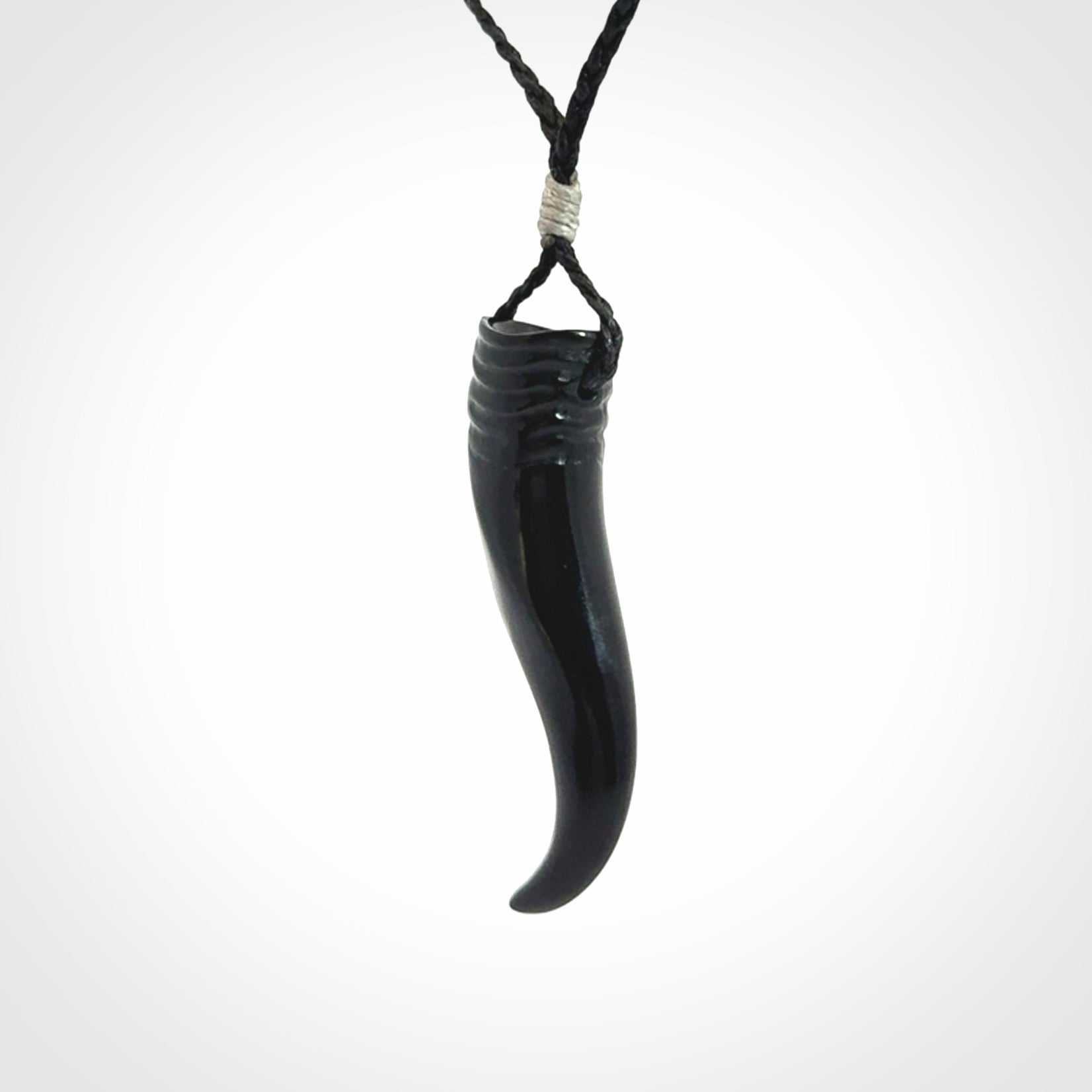 Black jade Italian Horn pendant. Handmade jade jewellery made by NZ Pacific and for sale online. Black Jade Goat Horn pendant worn for protection over evil eye, bad luck and promotes fertility. Ancient symbolic necklace hand made in Australian Black Jade.