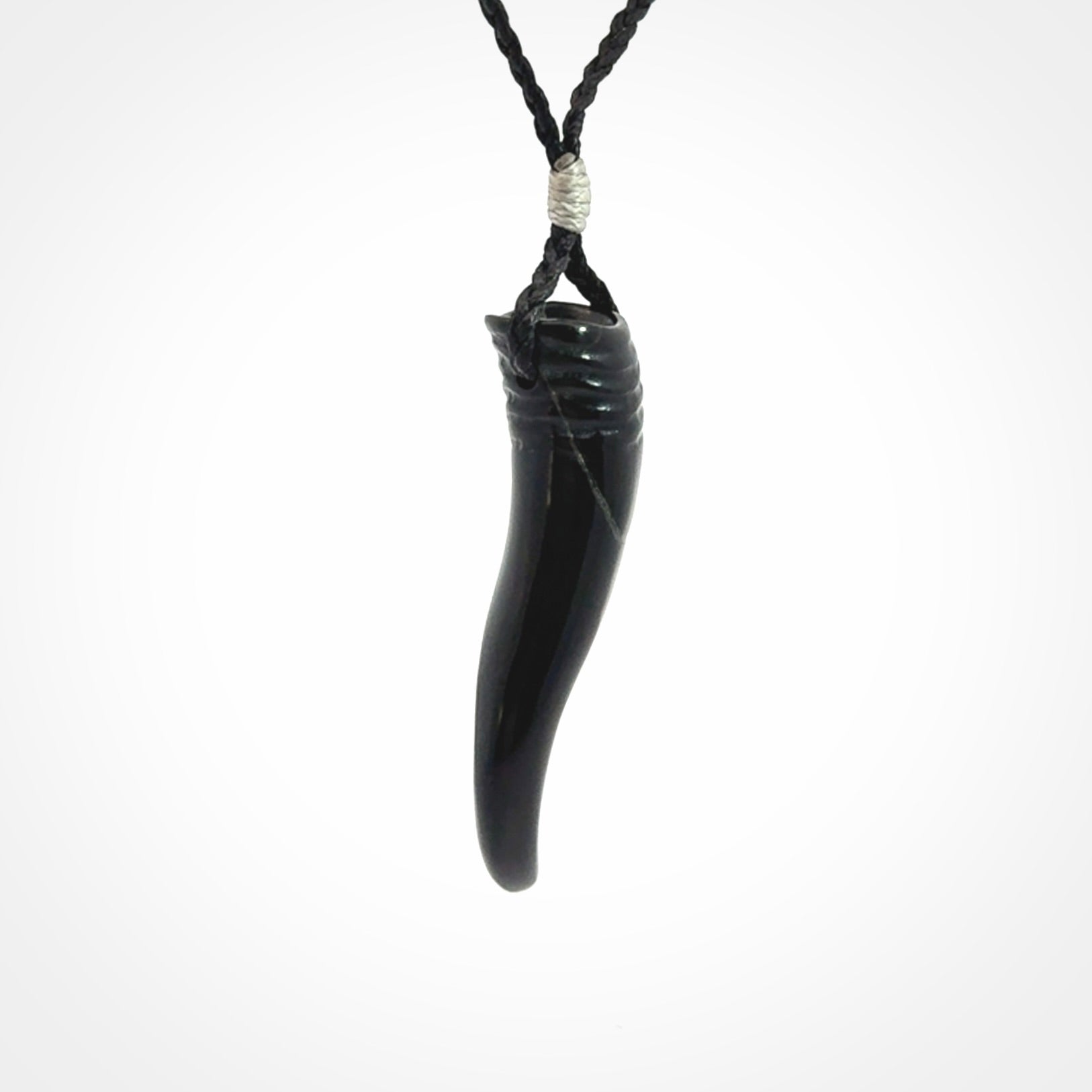 Black jade Italian Horn pendant. Handmade jade jewellery made by NZ Pacific and for sale online. Black Jade Goat Horn pendant worn for protection over evil eye, bad luck and promotes fertility. Ancient symbolic necklace hand made in Australian Black Jade.