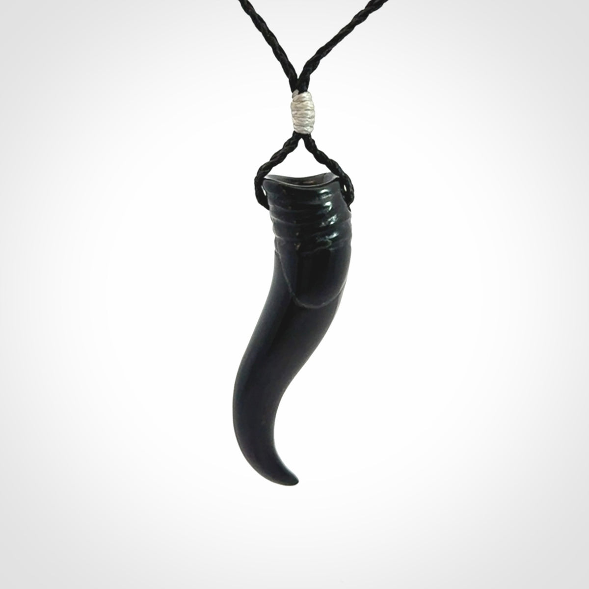 Black jade Italian Horn pendant. Handmade jade jewellery made by NZ Pacific and for sale online. Black Jade Goat Horn pendant worn for protection over evil eye, bad luck and promotes fertility. Ancient symbolic necklace hand made in Australian Black Jade.