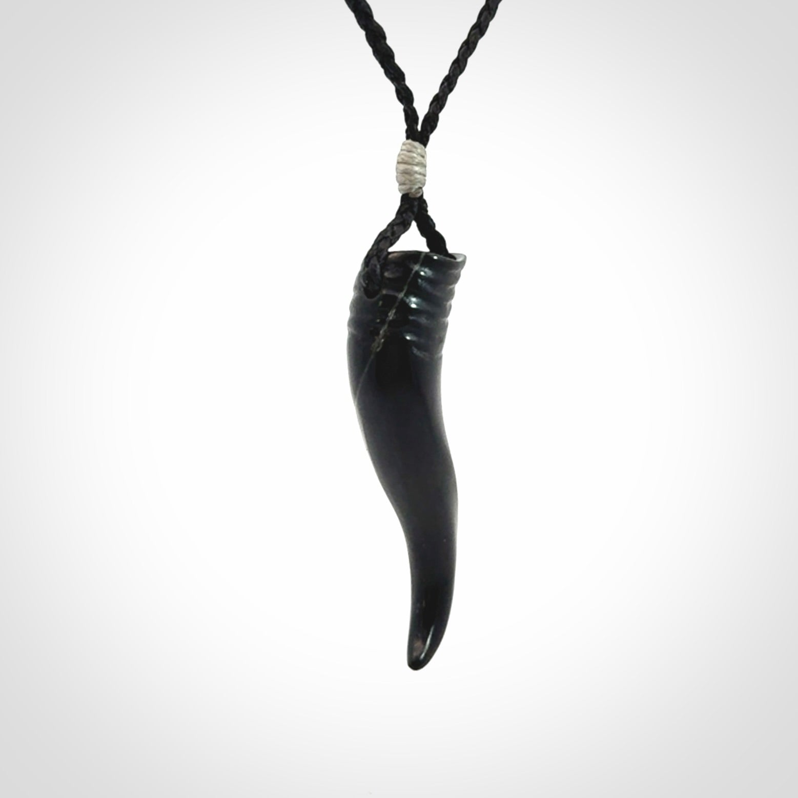 Black jade Italian Horn pendant. Handmade jade jewellery made by NZ Pacific and for sale online. Black Jade Goat Horn pendant worn for protection over evil eye, bad luck and promotes fertility. Ancient symbolic necklace hand made in Australian Black Jade.