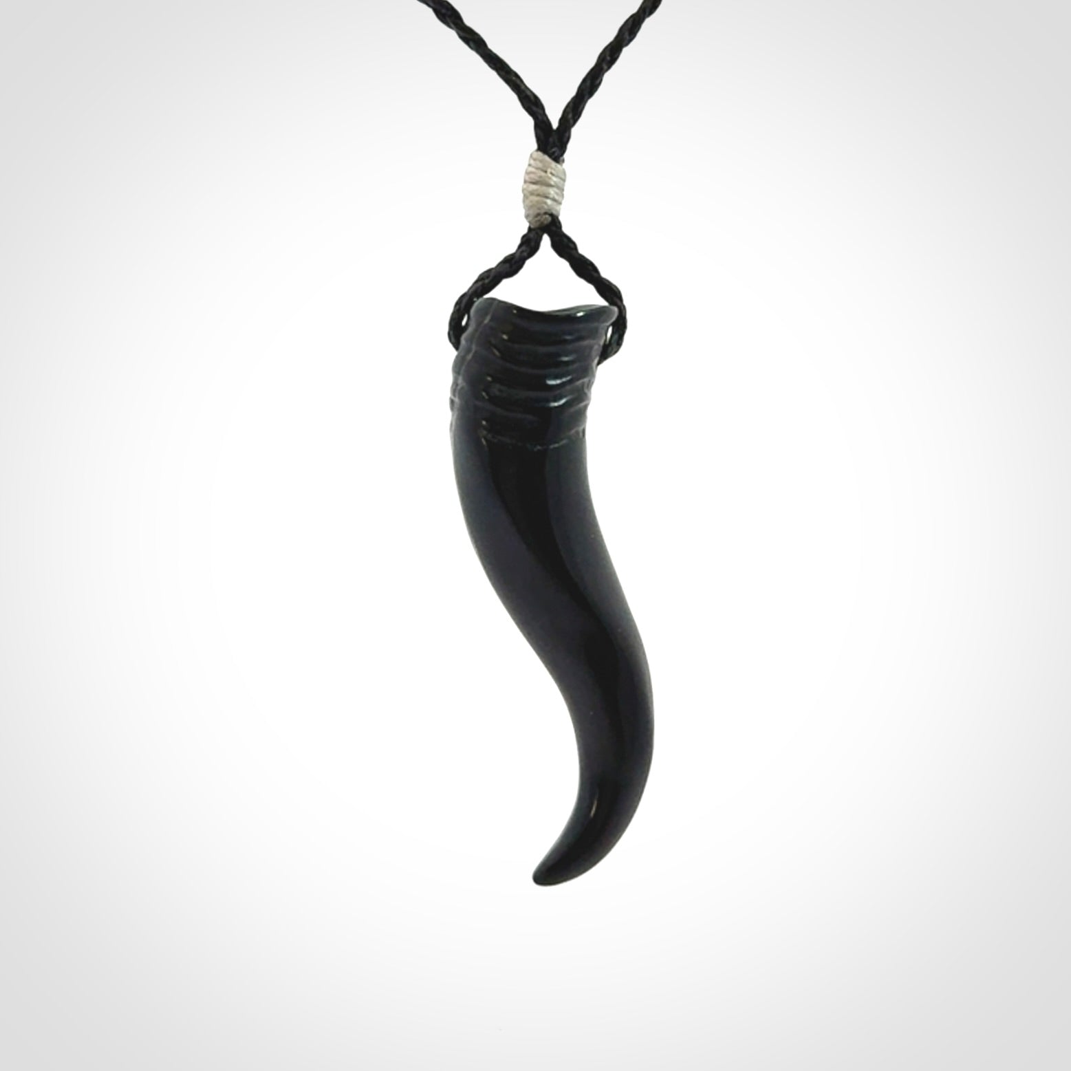 Black jade Italian Horn pendant. Handmade jade jewellery made by NZ Pacific and for sale online. Black Jade Goat Horn pendant worn for protection over evil eye, bad luck and promotes fertility. Ancient symbolic necklace hand made in Australian Black Jade.