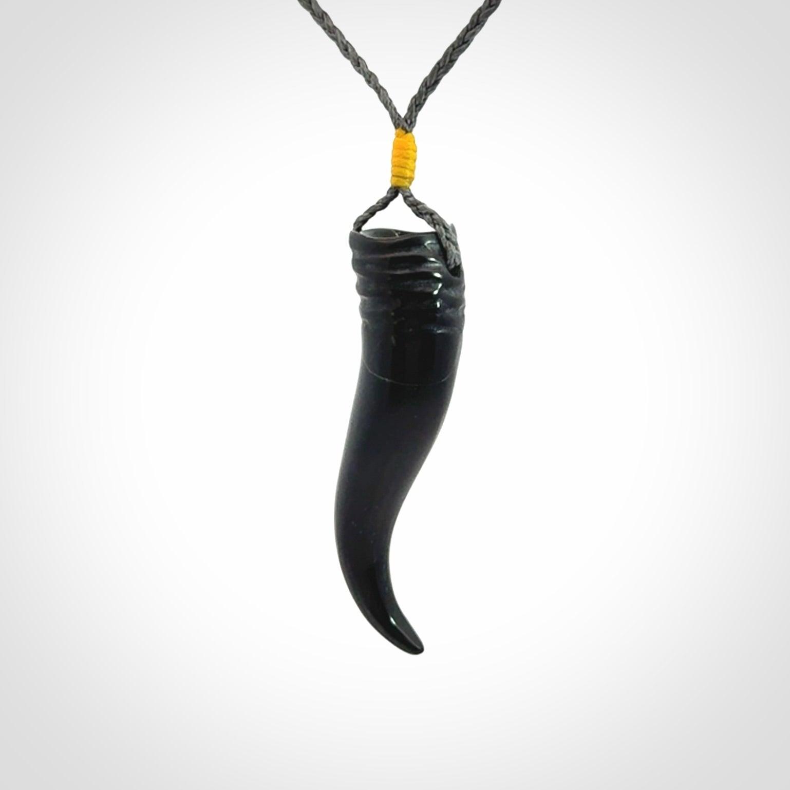 Black jade Italian Horn pendant. Handmade jade jewellery made by NZ Pacific and for sale online. Black Jade Goat Horn pendant worn for protection over evil eye, bad luck and promotes fertility. Ancient symbolic necklace hand made in Australian Black Jade.