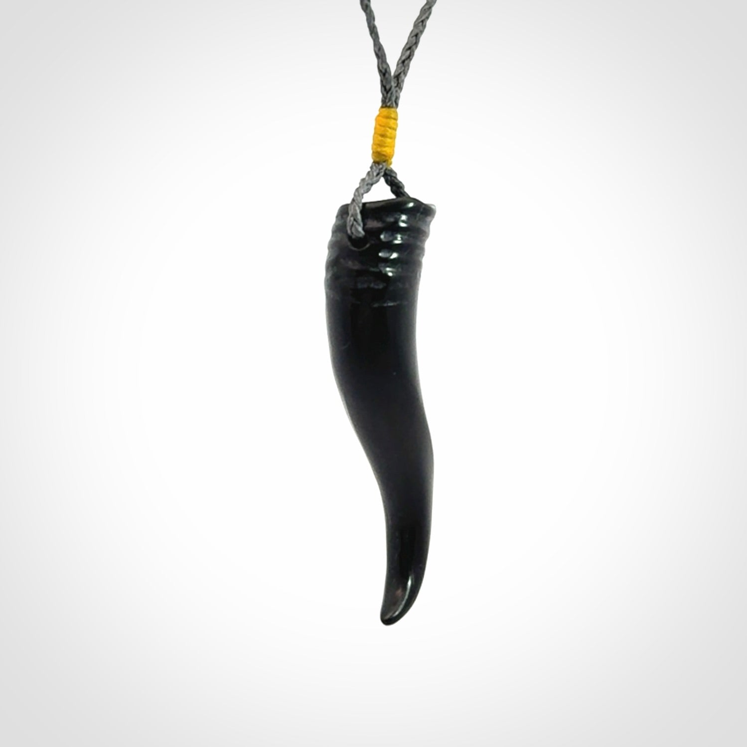 Black jade Italian Horn pendant. Handmade jade jewellery made by NZ Pacific and for sale online. Black Jade Goat Horn pendant worn for protection over evil eye, bad luck and promotes fertility. Ancient symbolic necklace hand made in Australian Black Jade.