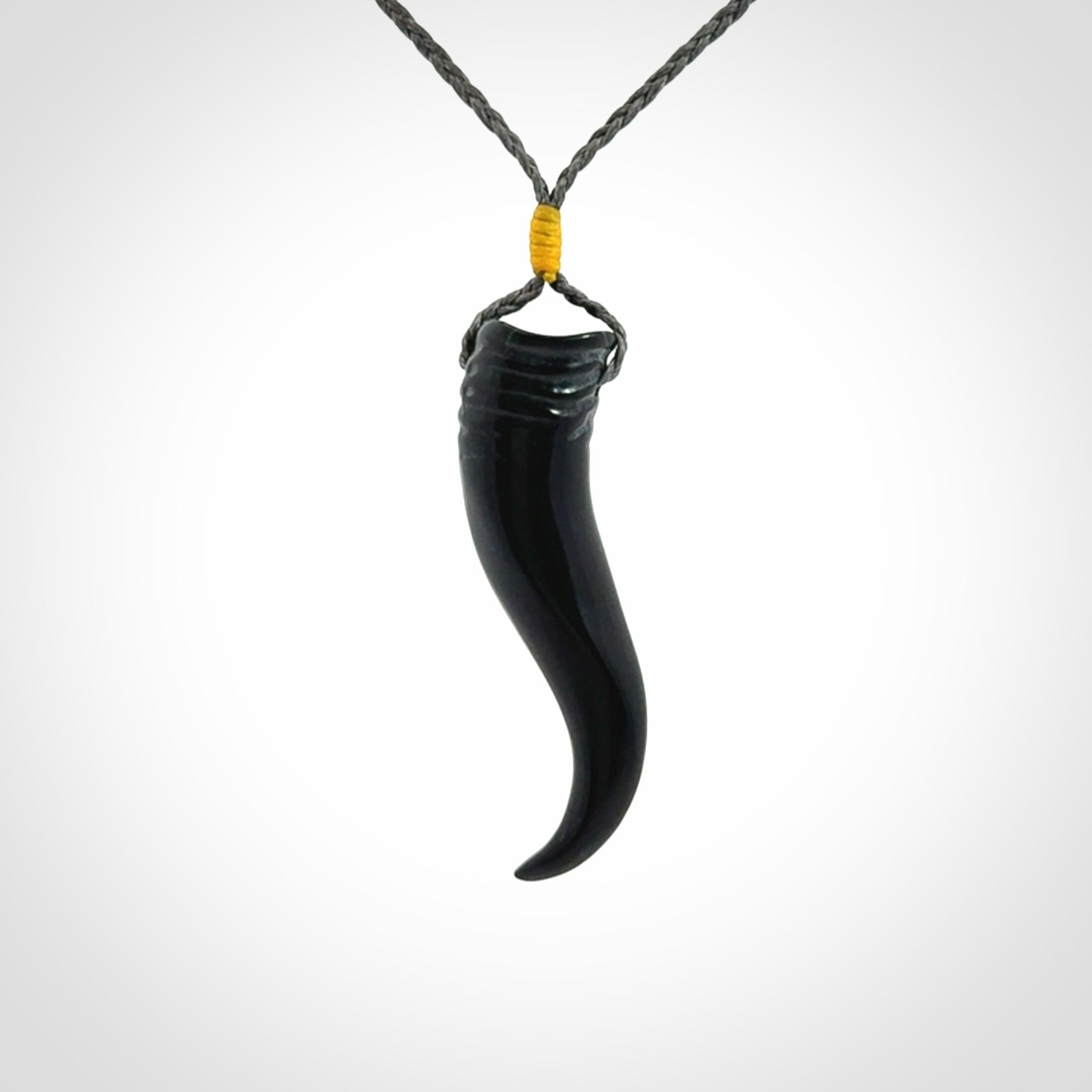Black jade Italian Horn pendant. Handmade jade jewellery made by NZ Pacific and for sale online. Black Jade Goat Horn pendant worn for protection over evil eye, bad luck and promotes fertility. Ancient symbolic necklace hand made in Australian Black Jade.