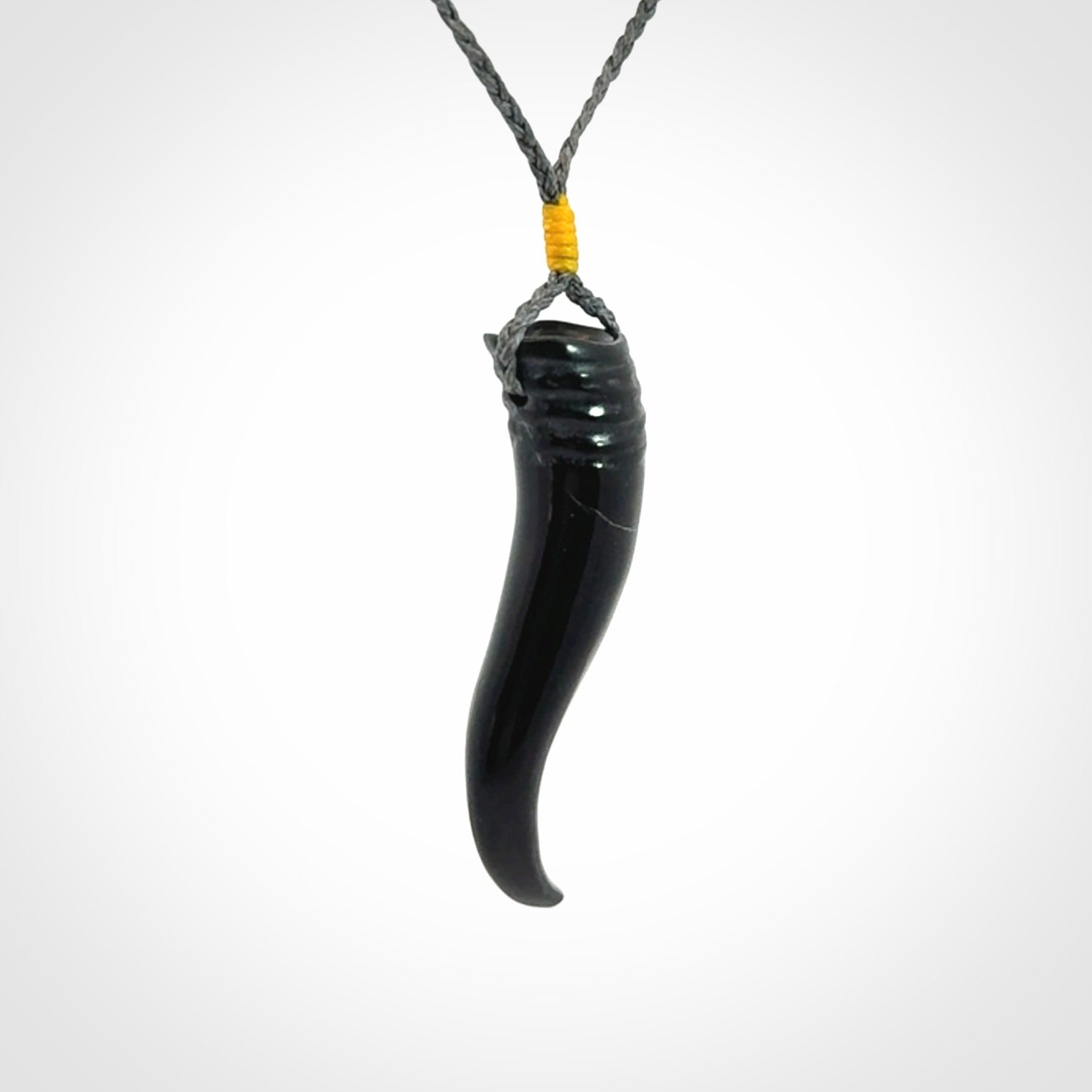 Black jade Italian Horn pendant. Handmade jade jewellery made by NZ Pacific and for sale online. Black Jade Goat Horn pendant worn for protection over evil eye, bad luck and promotes fertility. Ancient symbolic necklace hand made in Australian Black Jade.
