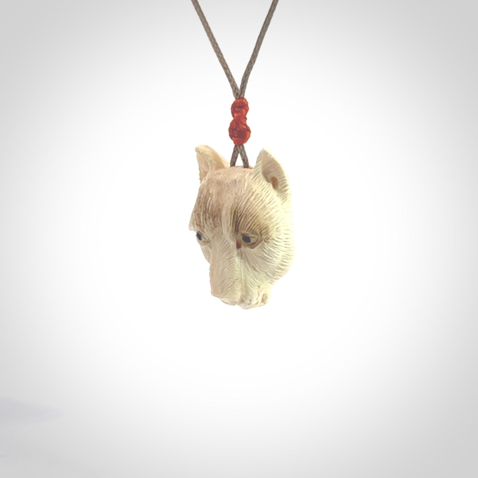 This pendant is a hand carved puma. We've carved this from a lovely piece of woolly mammoth tusk and we provide it with a hand plaited cord. Shipping is free worldwide.