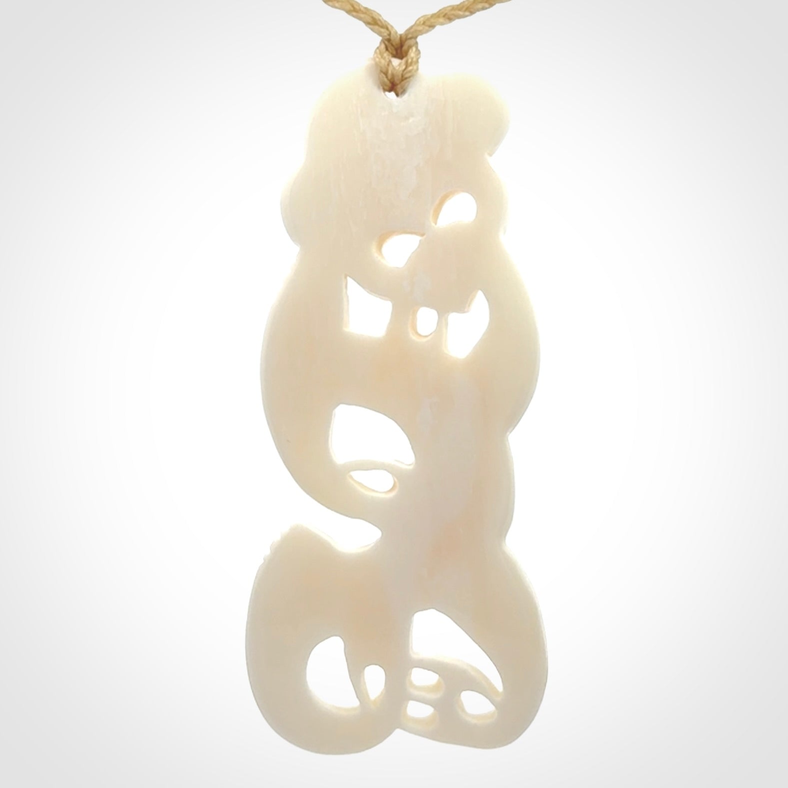 Hand carved bone Tiki pendant. Traditional art hand carved for NZ Pacific. Bone Tiki necklace with Paua Shell eyes. Delivered with Express Courier. Provided with adjustable cords and packaged in a woven kete pouch.