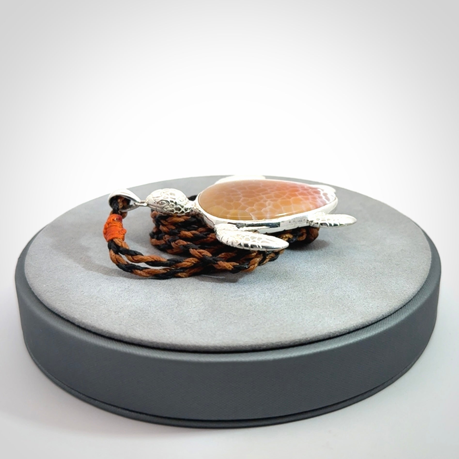 Snakeskin Agate stone turtle in Sterling silver engraved casing. Hand carved jewellery made by NZ Pacific and for sale online.