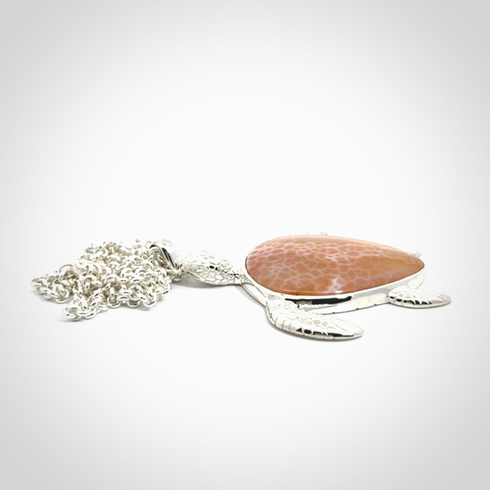 Snakeskin Agate stone turtle in Sterling silver engraved casing. Hand carved jewellery made by NZ Pacific and for sale online.