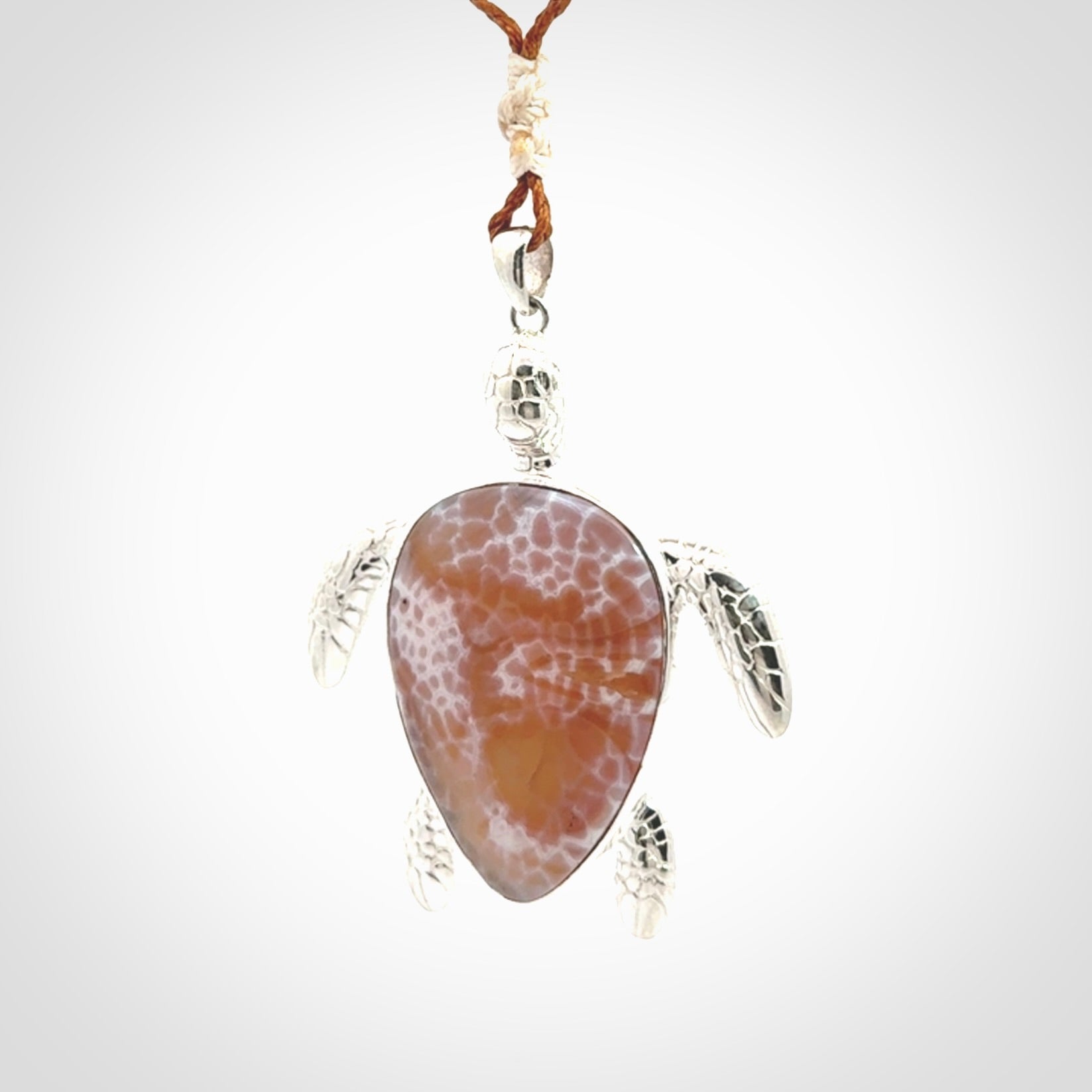 Snakeskin Agate stone turtle in Sterling silver engraved casing. Hand carved jewellery made by NZ Pacific and for sale online.