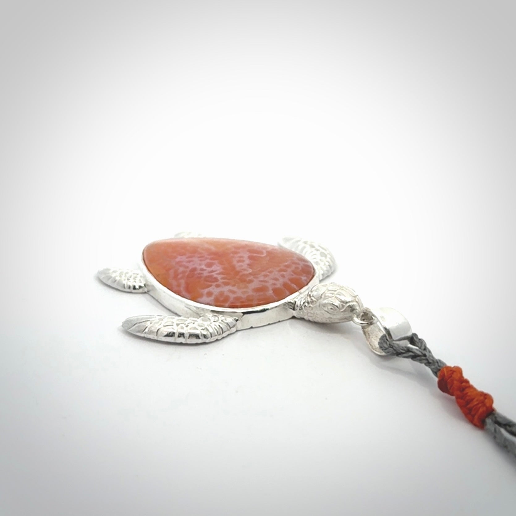 Snakeskin Agate stone turtle in Sterling silver engraved casing. Hand carved jewellery made by NZ Pacific and for sale online.