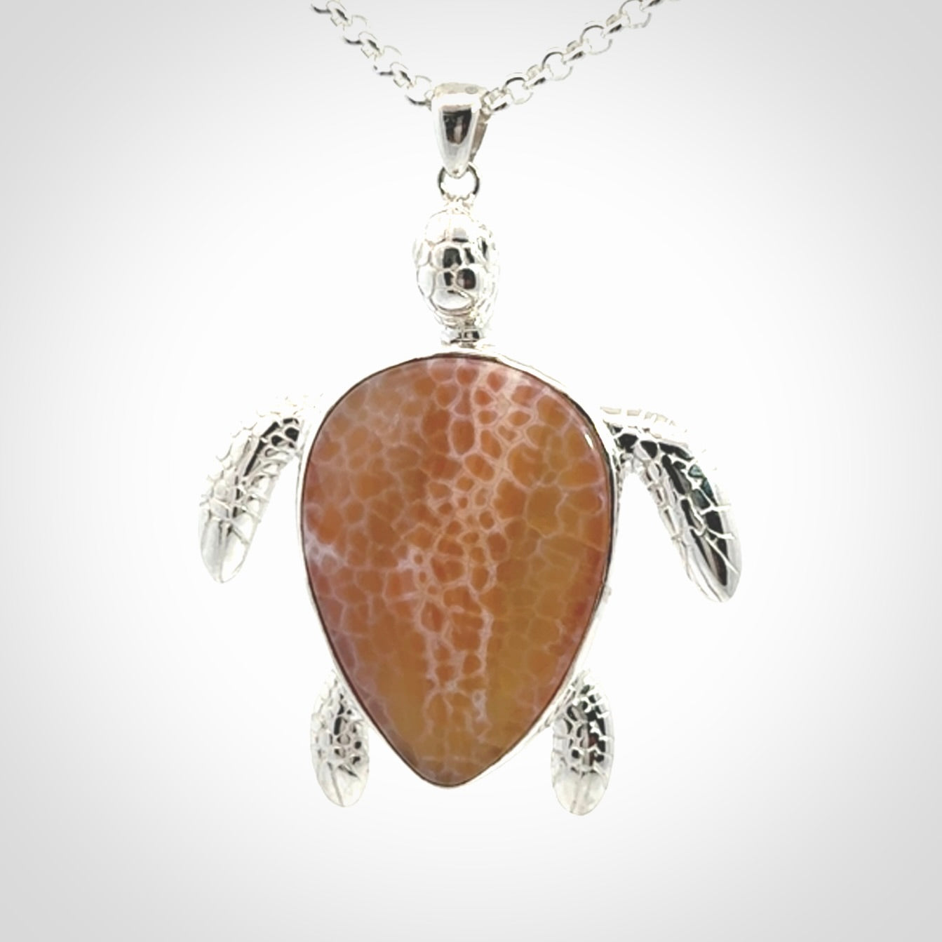 Snakeskin Agate stone turtle in Sterling silver engraved casing. Hand carved jewellery made by NZ Pacific and for sale online.