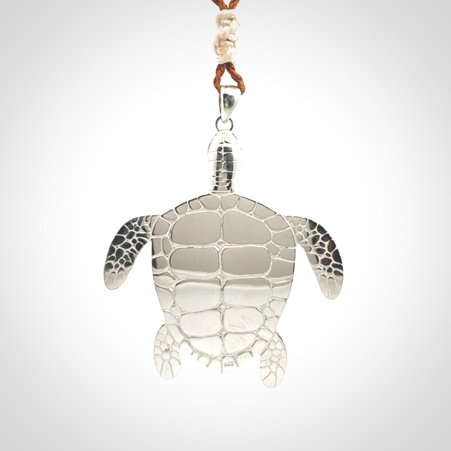 Snakeskin Agate stone turtle in Sterling silver engraved casing. Hand carved jewellery made by NZ Pacific and for sale online.