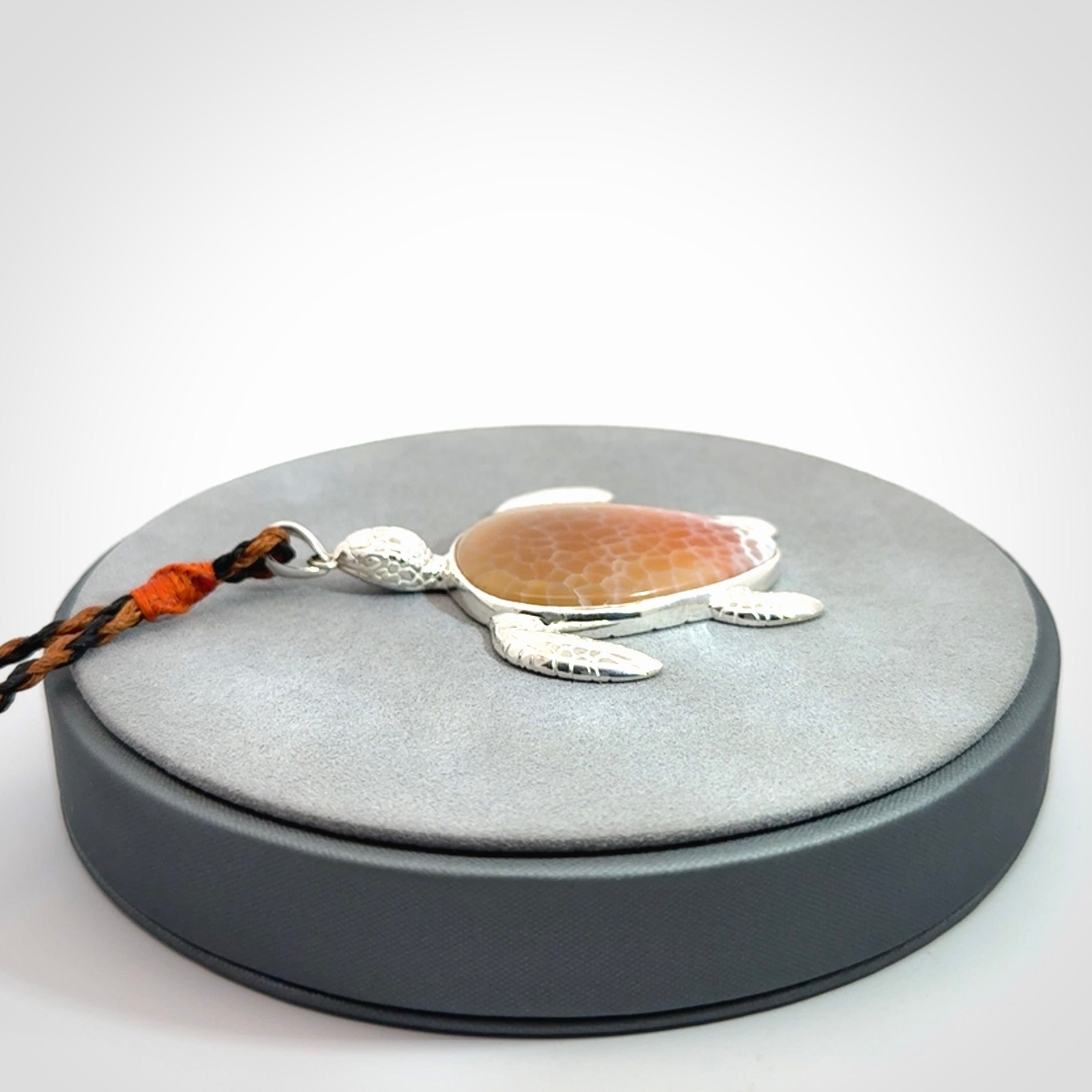 Snakeskin Agate stone turtle in Sterling silver engraved casing. Hand carved jewellery made by NZ Pacific and for sale online.