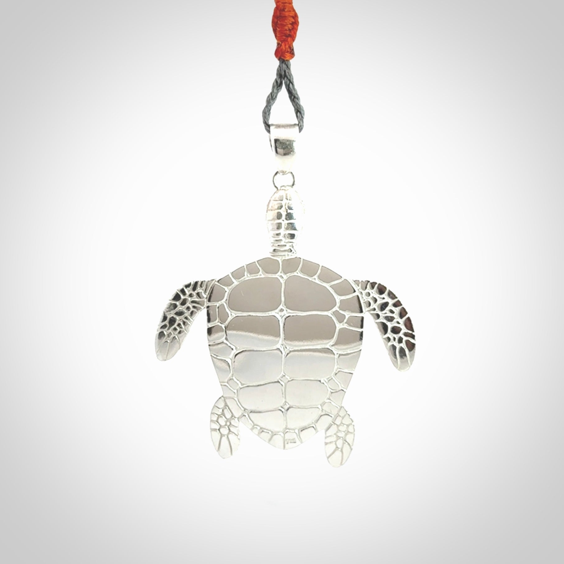 Snakeskin Agate stone turtle in Sterling silver engraved casing. Hand carved jewellery made by NZ Pacific and for sale online.