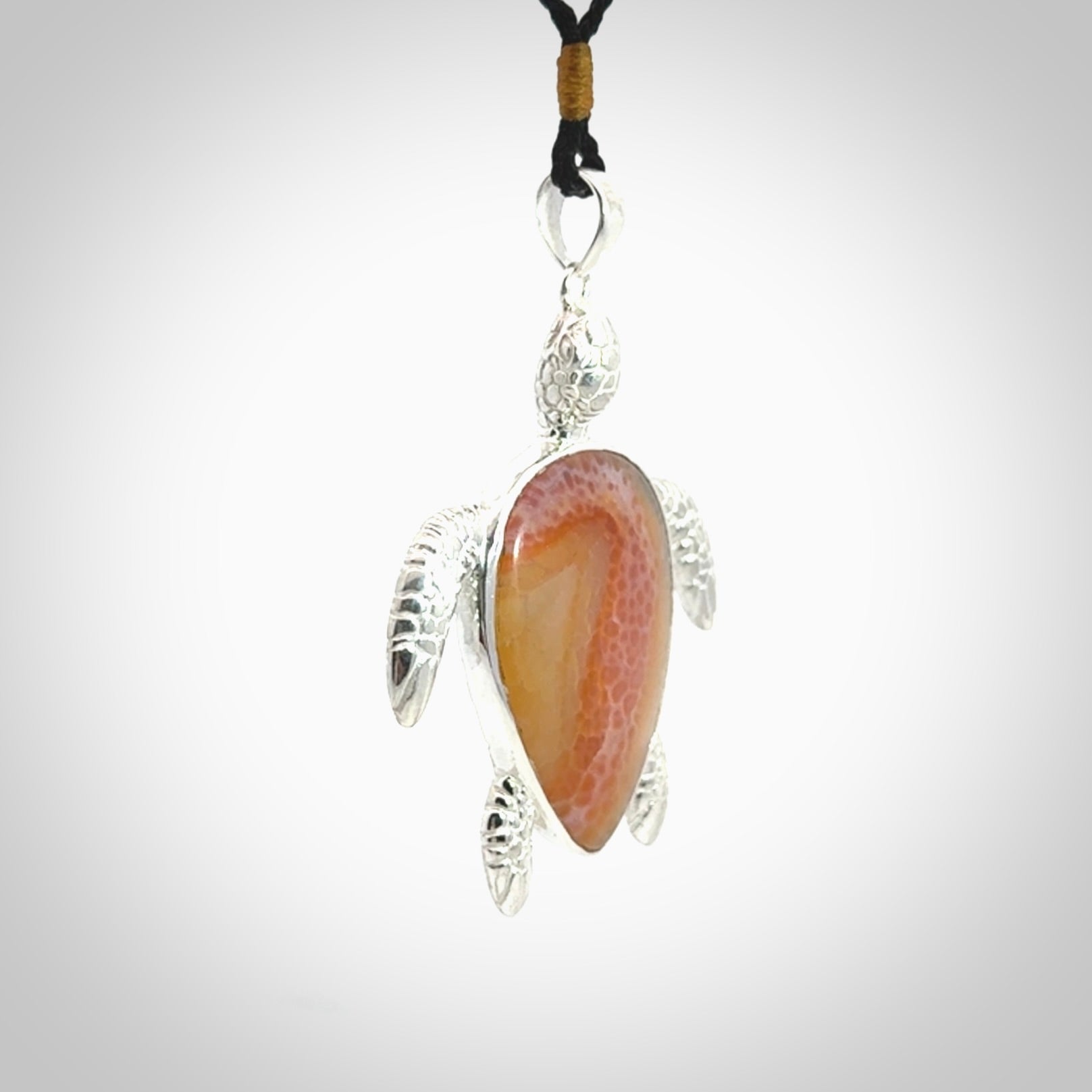 Snakeskin Agate stone turtle in Sterling silver engraved casing. Hand carved jewellery made by NZ Pacific and for sale online.