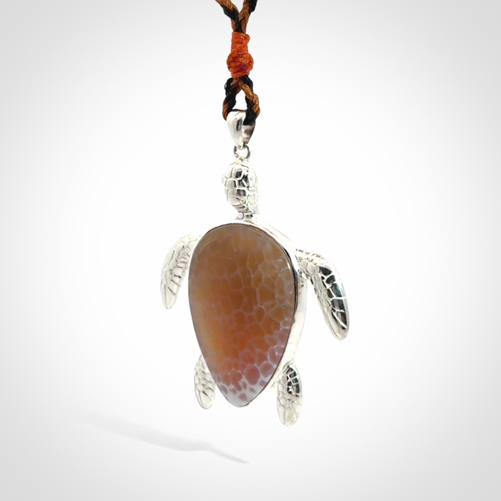 Snakeskin Agate stone turtle in Sterling silver engraved casing. Hand carved jewellery made by NZ Pacific and for sale online.