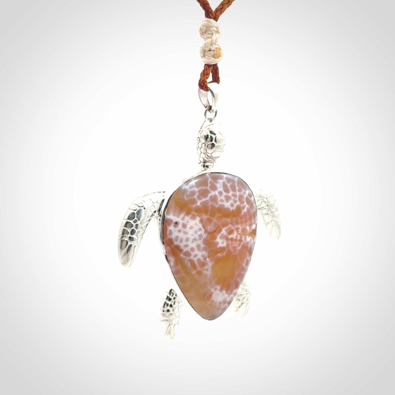 Snakeskin Agate stone turtle in Sterling silver engraved casing. Hand carved jewellery made by NZ Pacific and for sale online.