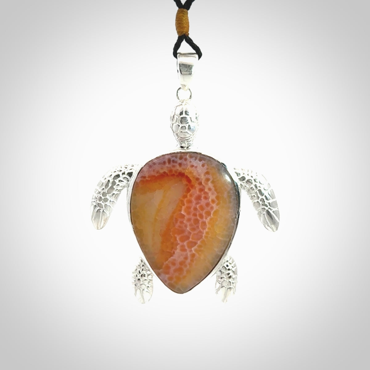 Snakeskin Agate stone turtle in Sterling silver engraved casing. Hand carved jewellery made by NZ Pacific and for sale online.