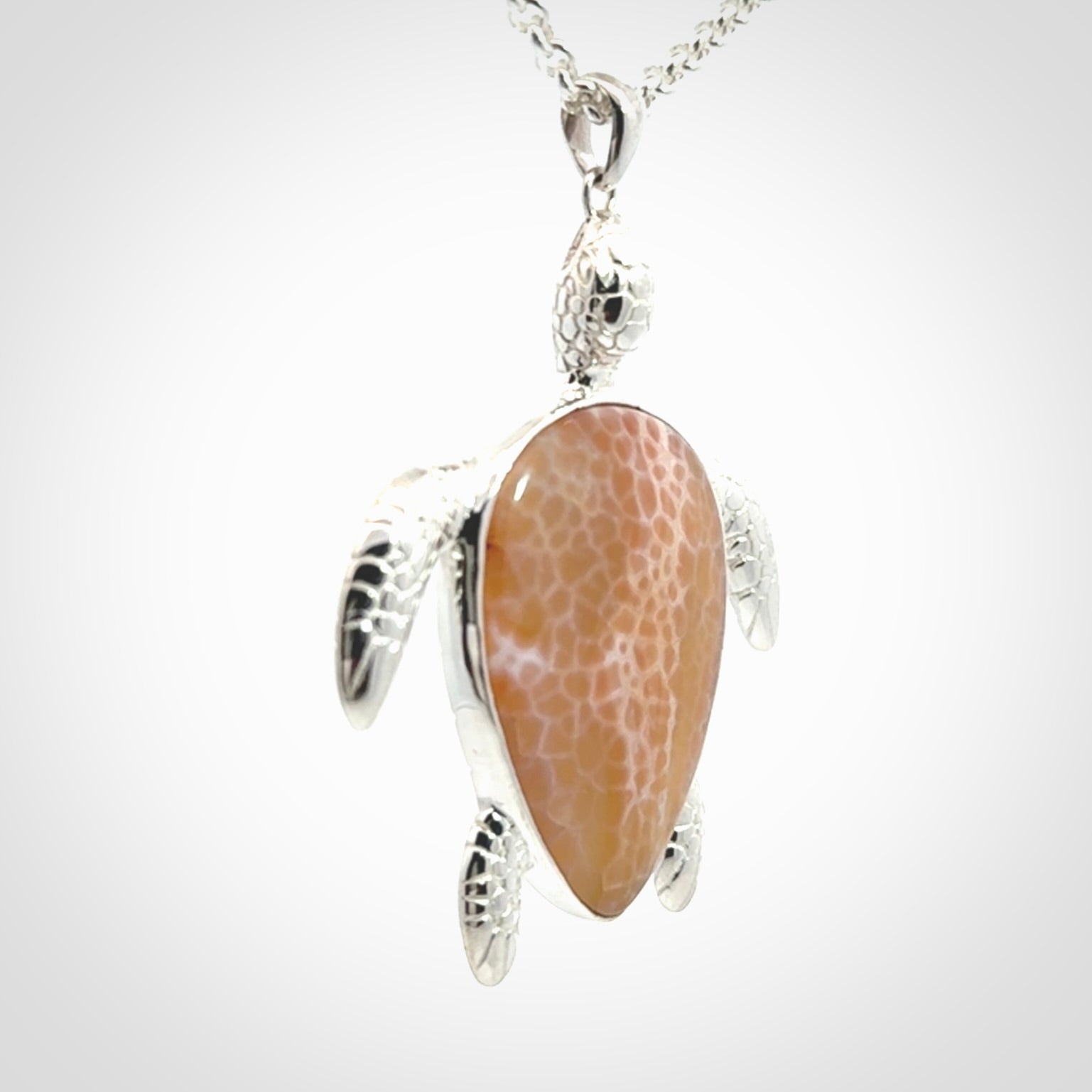 Snakeskin Agate stone turtle in Sterling silver engraved casing. Hand carved jewellery made by NZ Pacific and for sale online.