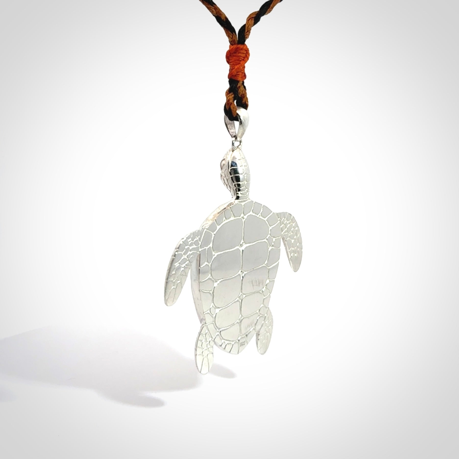 Snakeskin Agate stone turtle in Sterling silver engraved casing. Hand carved jewellery made by NZ Pacific and for sale online.