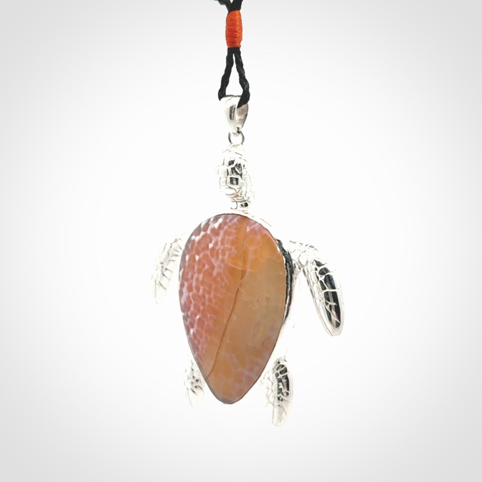 Snakeskin Agate stone turtle in Sterling silver engraved casing. Hand carved jewellery made by NZ Pacific and for sale online.