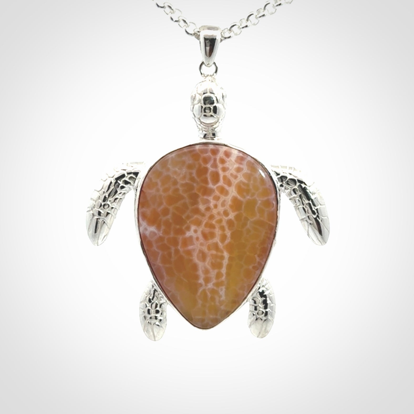 Snakeskin Agate stone turtle in Sterling silver engraved casing. Hand carved jewellery made by NZ Pacific and for sale online.