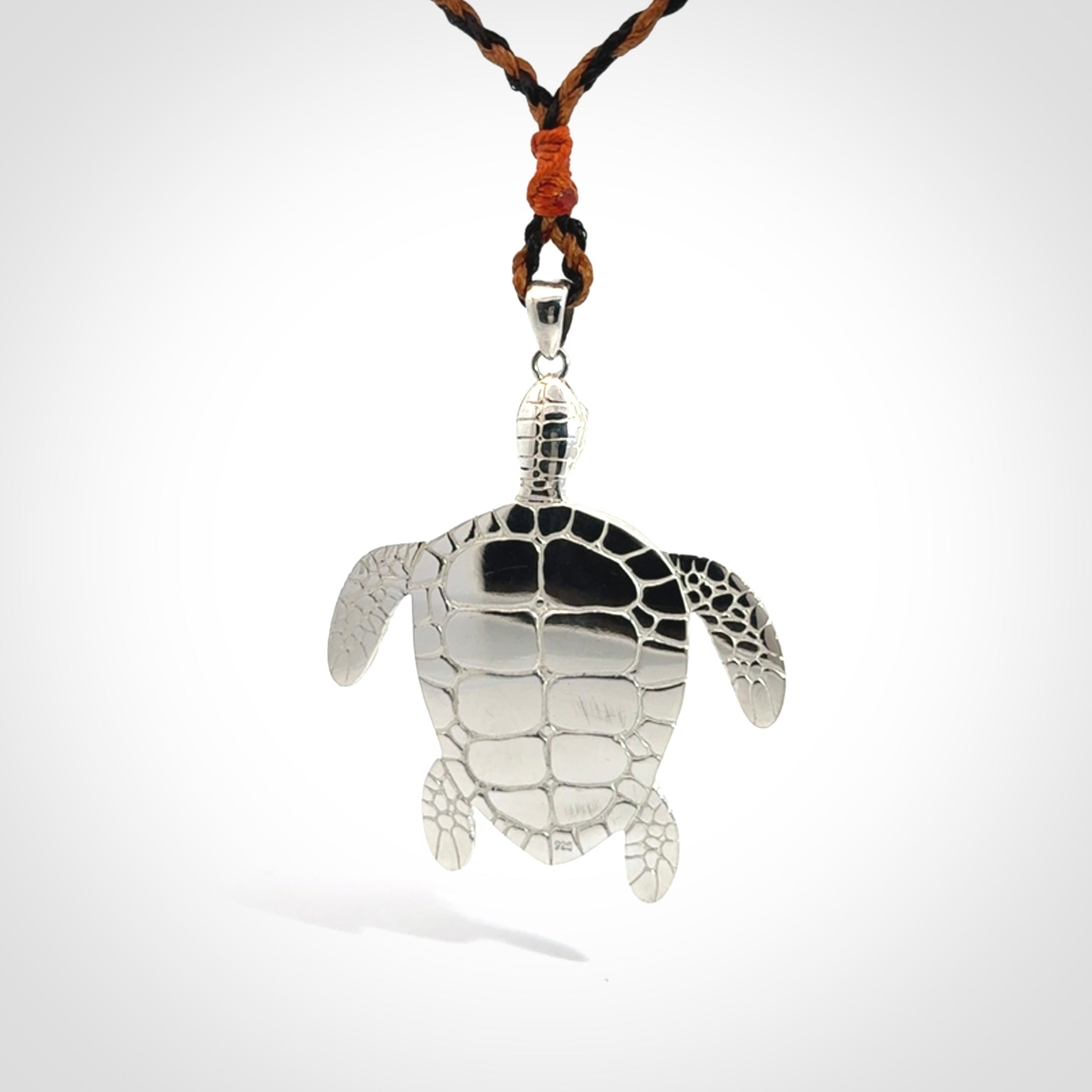 Snakeskin Agate stone turtle in Sterling silver engraved casing. Hand carved jewellery made by NZ Pacific and for sale online.