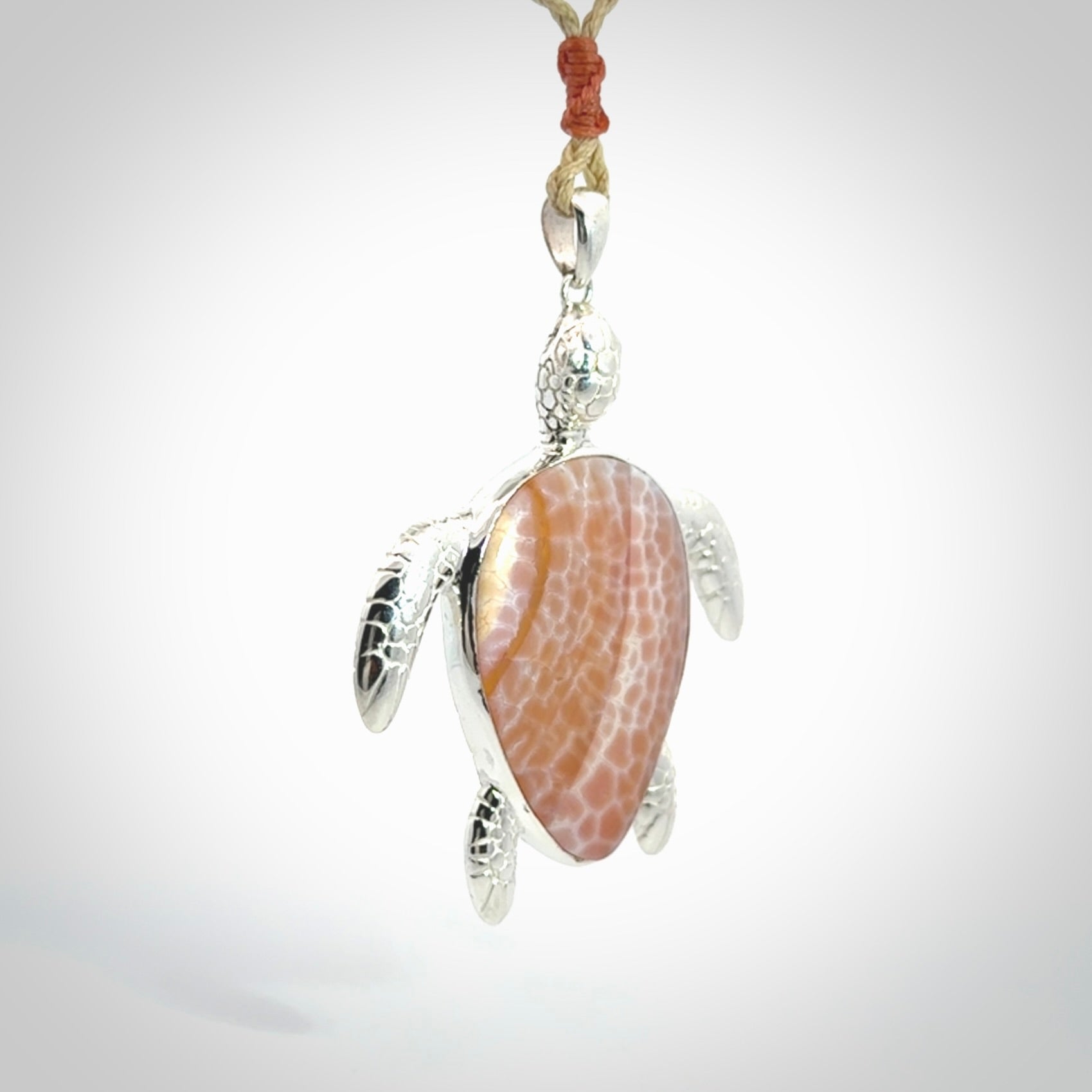 Snakeskin Agate stone turtle in Sterling silver engraved casing. Hand carved jewellery made by NZ Pacific and for sale online.