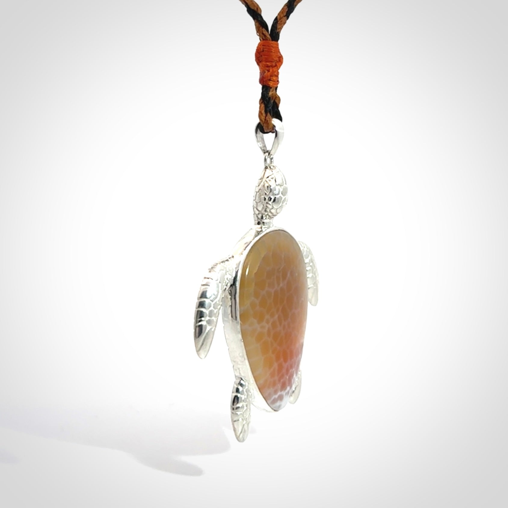 Snakeskin Agate stone turtle in Sterling silver engraved casing. Hand carved jewellery made by NZ Pacific and for sale online.