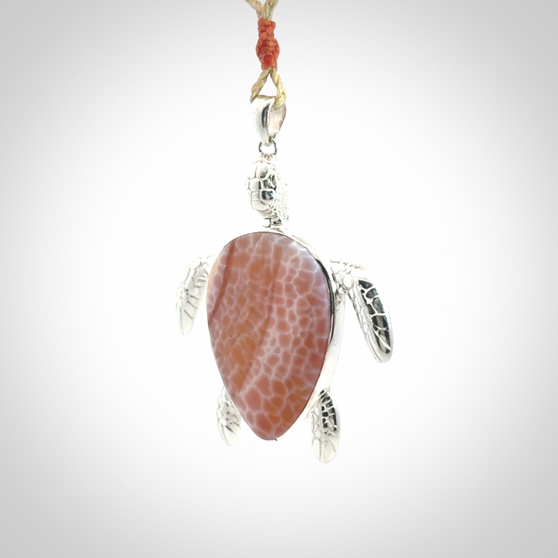 Snakeskin Agate stone turtle in Sterling silver engraved casing. Hand carved jewellery made by NZ Pacific and for sale online.