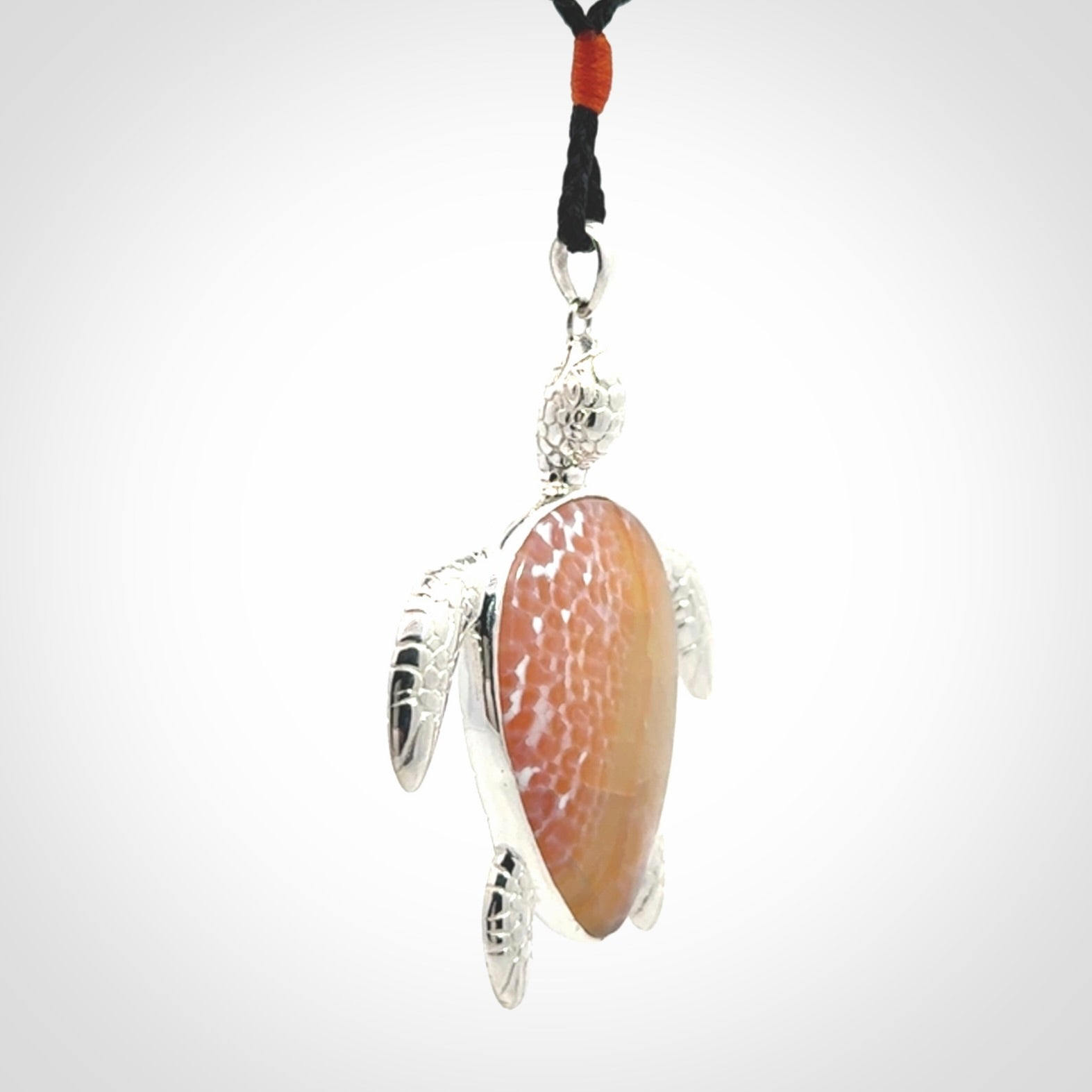 Snakeskin Agate stone turtle in Sterling silver engraved casing. Hand carved jewellery made by NZ Pacific and for sale online.