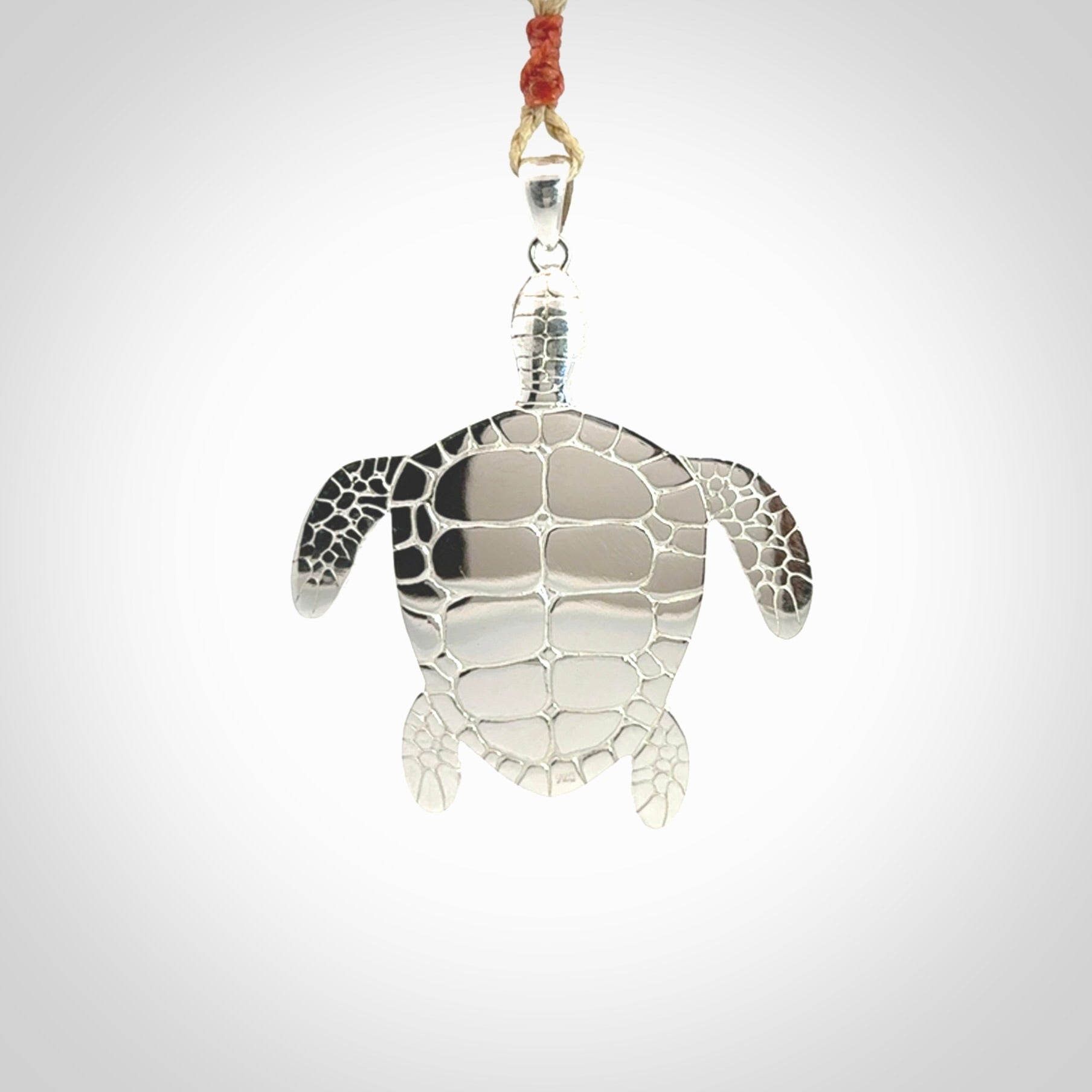 Snakeskin Agate stone turtle in Sterling silver engraved casing. Hand carved jewellery made by NZ Pacific and for sale online.