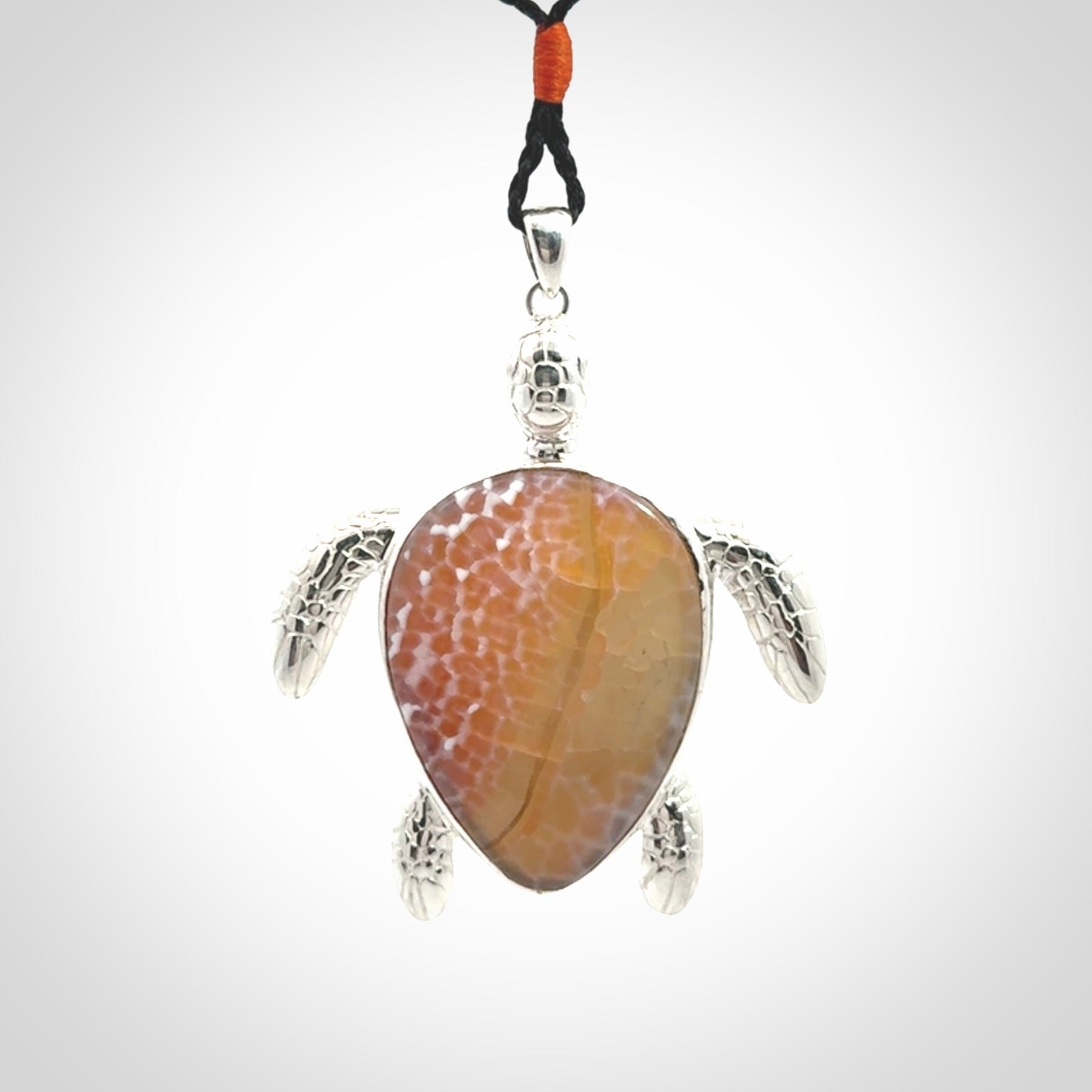 Snakeskin Agate stone turtle in Sterling silver engraved casing. Hand carved jewellery made by NZ Pacific and for sale online.