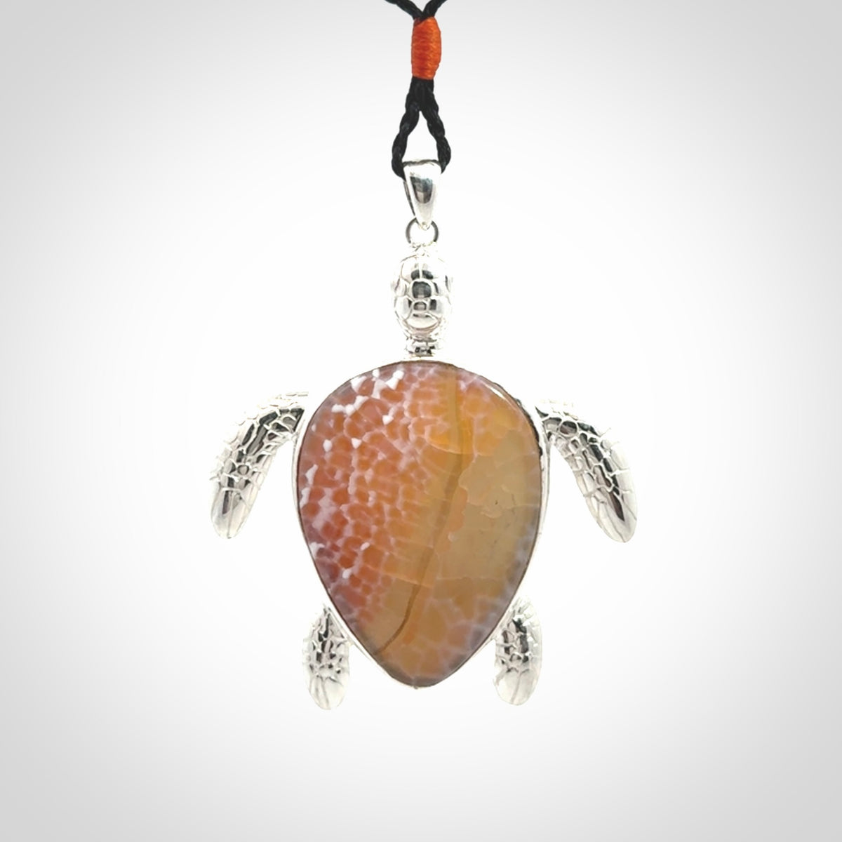 Snakeskin Agate stone turtle in Sterling silver engraved casing. Hand carved jewellery made by NZ Pacific and for sale online.